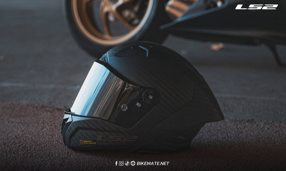 LS2 FF805 racing helmet placed on the ground next to a motorcycle – representing high-performance gear for sport riders