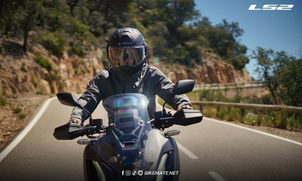 Motorcyclist wearing a safety helmet riding on the road 